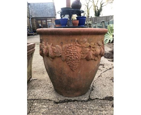 A LARGE TERACOTTA TERRACE PLANTER WITH FRUITING VINE DECOARATION.