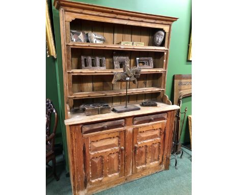 A LATE 19th C. PINE DRESSER, THE ENCLOSED THREE SHELF BACK ABOVE A BASE WITH TWO DRAWERS ABOVE DOORS WITH PANELS WITHIN CHIP 
