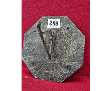 AN 18TH CENTURY BRASS SUNDIAL, ENGRAVED DECORATION OF FATHER TIME WITHIN THE ARRAY OF NUMERALS AND DATED 1760. 15.5 cm  X 15.