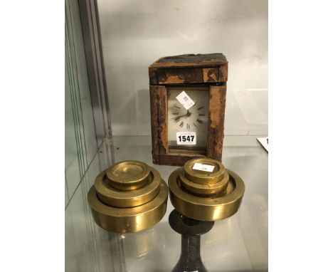 A CASED CARRIAGE CLOCK STRIKING ON A COILED ROD TOGETHER WITH SIX BRASS WEIGHTS