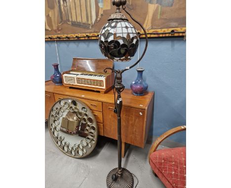 A TIFFANY STYLE STANDARD LAMP WITH LEADED GLASS GLOBE FORM SHADE.