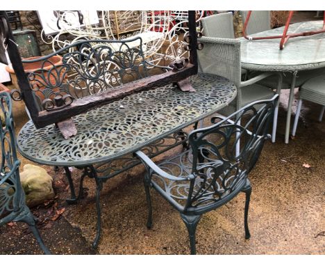 A GREEN PAINTED CAST ALLOY PATIO TABLE WITH MATCHING BENCH AND CHAIR.