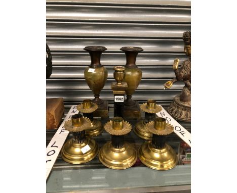 A SET OF FIVE BRASS CANDLESTICKS WITH BLACK FLUTED COLUMNS ANOTHER CANDLESTICK AND A PAIR OF ONYX BALUSTER VASES