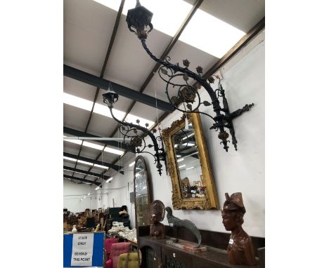 A PAIR OF IRON LIGHT BRACKETS, THE HEXAGONAL SHADES RAISED ON SINUOUS ARMS APPLIED WITH GILT FLOWER HEADS. H 155 W 75 cm
