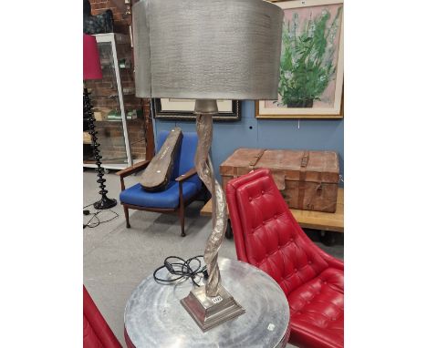 A PAIR OF ALUMINIUM TABLE LAMPS AND SHADES, THE SINUOUS TREE TRUNK COLUMNS SUPPORTED ON SQUARE FEET