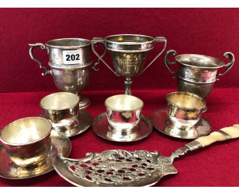 THREE SILVER TWO HANDLED TROPHY CUPS, 307Gms. TOGETHER WITH A MOTHER OF PEARL HANDLED FISH SLICE AND FOUR TEA BOWLS AND SAUCE