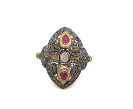 A POLKI DIAMOND AND RUBY PIERCED WORK LARGE PANEL RING MOUNTED IN SILVER GILT. FINGER SIZE N. WEIGHT 14.69grms.