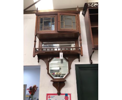 AN EARLY 20th C. MIRROR BACKED MAHOGANY WALL UNIT WITH LEADED GLASS DOORS ABOVE A BALUSTRADED SHELF AND A BOW FRONTED SHELF