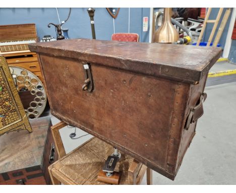 A 19TH CENTURY LEATHER BOUND COACHING TRUNK WITH IRON FITTINGS.