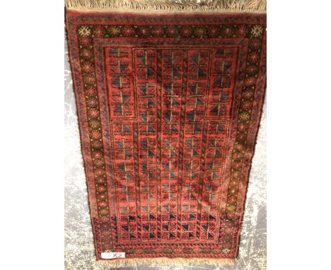 A BELOUCH TRIBAL PRAYER RUG. 148 x 96cms TOGETHER WITH A VINTAGE HOOKED RUG. 140 x 86cms (2)