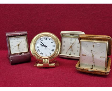 A VINTAGE CARTIER DESK CLOCK, A  LOOPING SWISS TRAVEL CLOCK IN FOLDING RED LEATHER BOUND CASE, A FURTHER LATER LOOPING CLOCK 