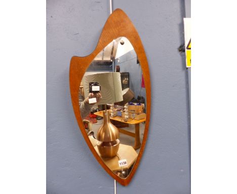 A PLECTRUM SHAPED MIRROR MOUNTED ON AN OAK BACK OF PALETTE SHAPE.   H 68cms.