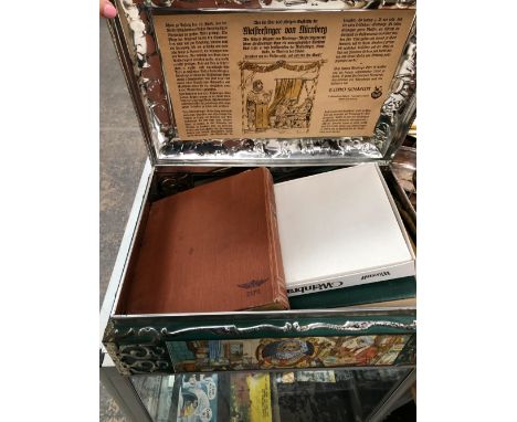 A COLLECTION OF VINTAGE GB AND WORLD STAMPS LOOSE AND IN ALBUMS CONTAINED IN A LARGE GERMAN BISCUIT BOX.