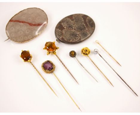 A late 19th century citrine stick pin, the oval cut citrine within a yellow metal six claw setting with flat trefoil and ball