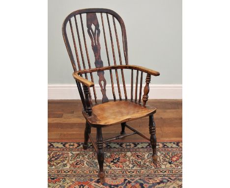 * A 19th century ash and alder wood hoop back Windsor farmhouse chair, the stick back centred with a pierced splat over a sha