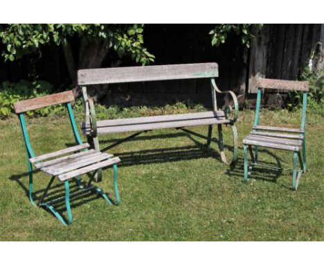 * A scrolling wrought iron and slatted hardwood garden bench, early 20th century, 122cm wide, along with two matched but non-
