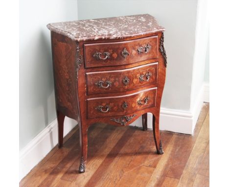 * A Louis XVI kingwood and marquetry petite commode chest, late 19th century, the shaped rouge marble top above an arrangemen