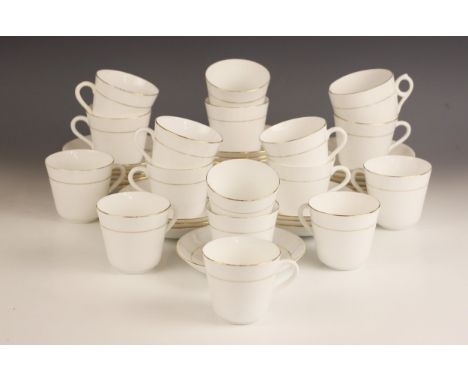A collection of Salon China teacups and saucers, each white glazed with gilt floral detail within gilt banding, comprising se