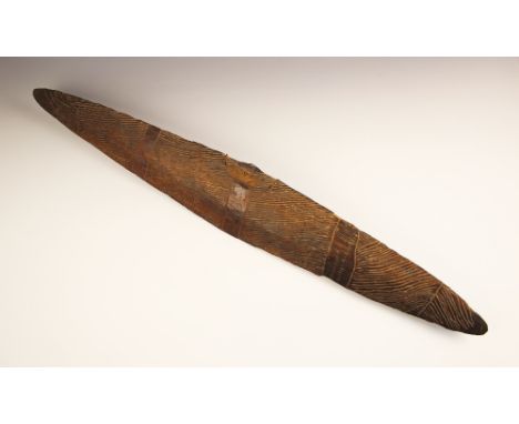 A 19th century South Eastern Australia Aboriginal shield with carved decoration and carved handle to the reverse, remains of 
