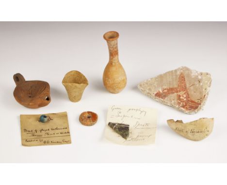 A selection of antiquities, including a slab of stucco with applied label 'stucco taken from the hall of a house at Pompei by