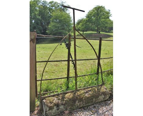 * A sandstone and wrought iron garden roller 135cm H x 104cm W 