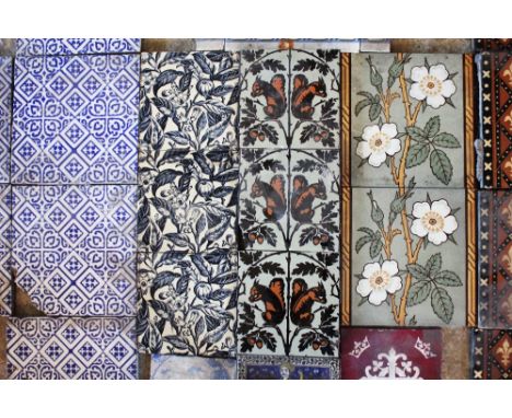 Three Minton &amp; Co glazed ceramic tiles, each decorated with a stylised back-to-back squirrel pattern, each 15.2cm x 15.2c