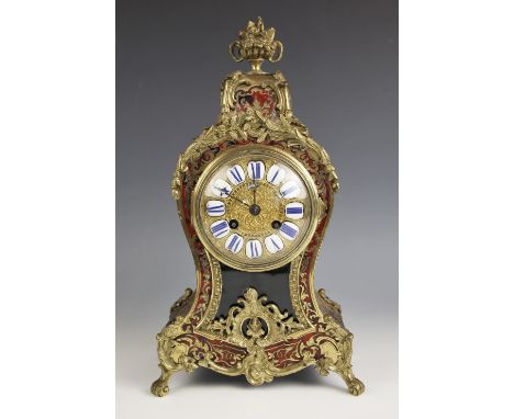 A French gilt metal and Boulle work mantel clock, late 19th century, of waisted balloon form, the cast floral un finial above