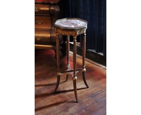 * A Louis XVI style walnut jardinere stand, late 19th century, the octagonal rouge marble top with a pierced lattice gilt met