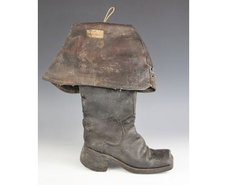 A Charles I English civil war leather cavalry boot circa. 1640, with folded upper, tapering to leather soles and a square toe