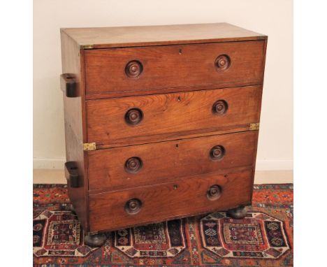 * A 19th century twin section teak campaign chest of drawers, applied with brass corner brackets and side lug handles to both