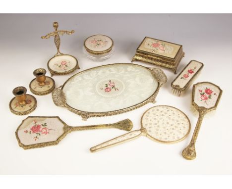 A gilt metal dressing table set, 20th century, comprising Thorens music box/jewellery box, a pair of dwarf candlesticks, clot