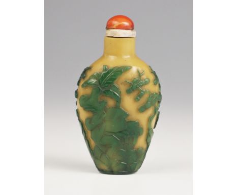 A Chinese Peking glass green overlay, yellow snuff bottle, 19th century, of high shouldered form, depicting a house within a 
