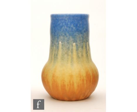 Ruskin Pottery - A crystalline vase of swollen ovoid form with tall collar neck decorated in a streaked and mottled blue to y