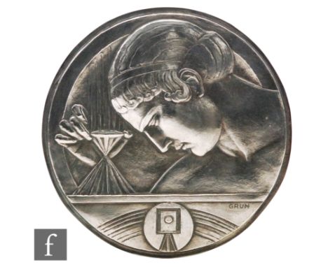 Grun - A French cast silvered circular plaque relating to cinema profile of a woman above a tripod camera, diameter 20cm 