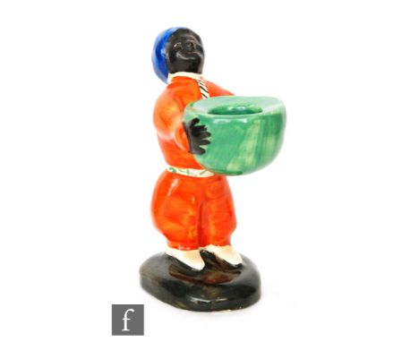 Clarice Cliff - Arab - A novelty candlestick modelled as a standing Arab in pantaloons with sash and turban holding a basket,