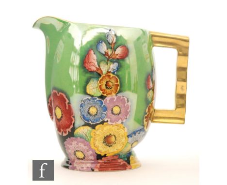 Carlton Ware - A 1930s Art Deco Moderne shape jug decorated in the gilt and enamel Hollyhocks pattern against a green lustre 