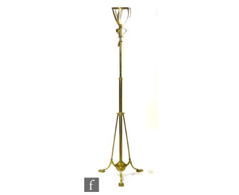 Unknown - A brass standard lamp raised to three splayed supports with flattened feet, united by a spherical shaped finial.