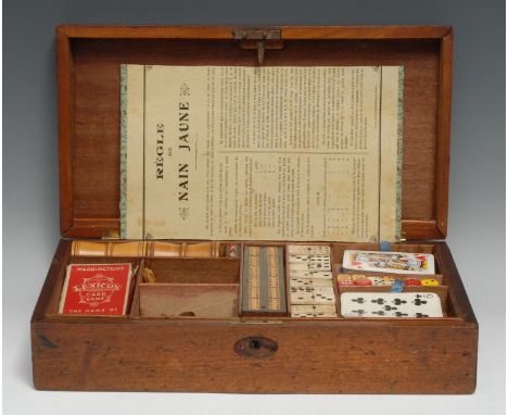 A late Victorian/Edwardian mahogany games compendium box, hinged cover enclosing an arrangement of playing cards, chess piece