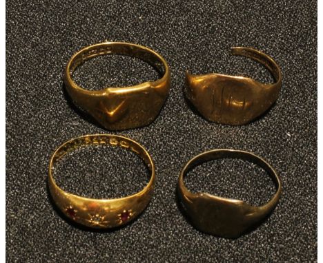 An 18ct gold ring, set with two ruby chips, 2.6g; a 9ct gold signet ring, a 9ct gold broken ring, 6.3g; a silver ring, 1.7g (