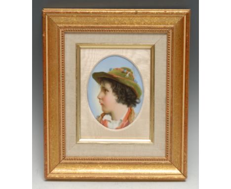 A German porcelain oval plaque, painted with the profile of a young peasant boy, in traditional national dress, 12.5cm x 9.5c