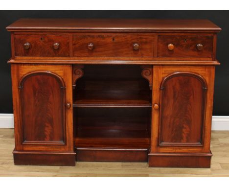 A Victorian mahogany sideboard, moulded rectangular top above three frieze drawers, the base with a centred bookcase niche fl