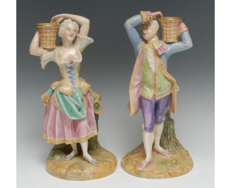 A pair of Royal Worcester figural candlesticks, of a gentleman and lady, both in 18th century dress, carrying basket on their