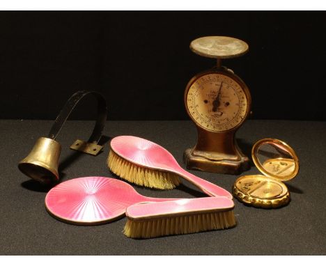 A silver engine turned pink enamel dressing table set, hand mirror and two brushes, Birmingham 1929; a Kigu Minuette musical 