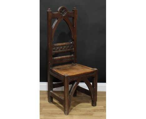 A Victorian Gothic Revival country house hall chair, arched cresting rail carved with a foliate quatrefoil, the verso with a 