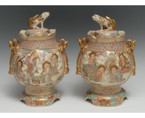 A pair of Japanese Satsuma pedestal vases, painted with elders competing at games or making music together within inset shape