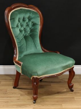 A Victorian mahogany nursing chair, trefid spoon back, serpentine seat, cabriole forelegs, 94.5cm high, 59cm wide, the seat 4