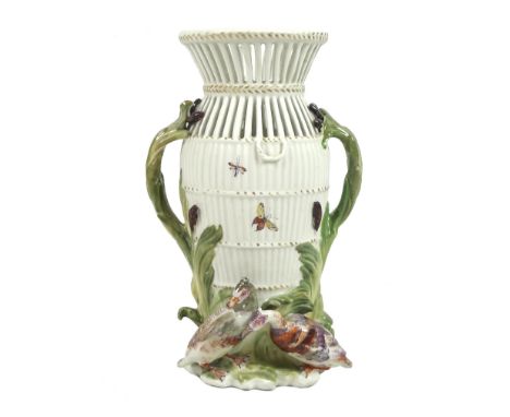 A Chelsea-Derby porcelain reticulated eel-trap vase, circa 1760, emblematic of 'Water', inspired by a Meissen model, part of 