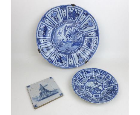 Three pieces of 19th century Delft blue and white ceramics, a later 19th century charger with a river bank scene with birds a