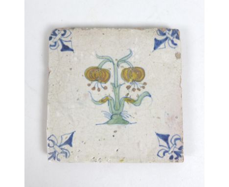 A 17th century Delft polychrome tile, decorated with a central flower and with a fleur-de-lis to each corner,with Dutch label