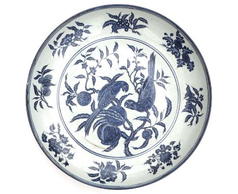 A large Chinese Ming style blue and white dish, probably early 20th century, decorated in underglaze blue heaped and piled st